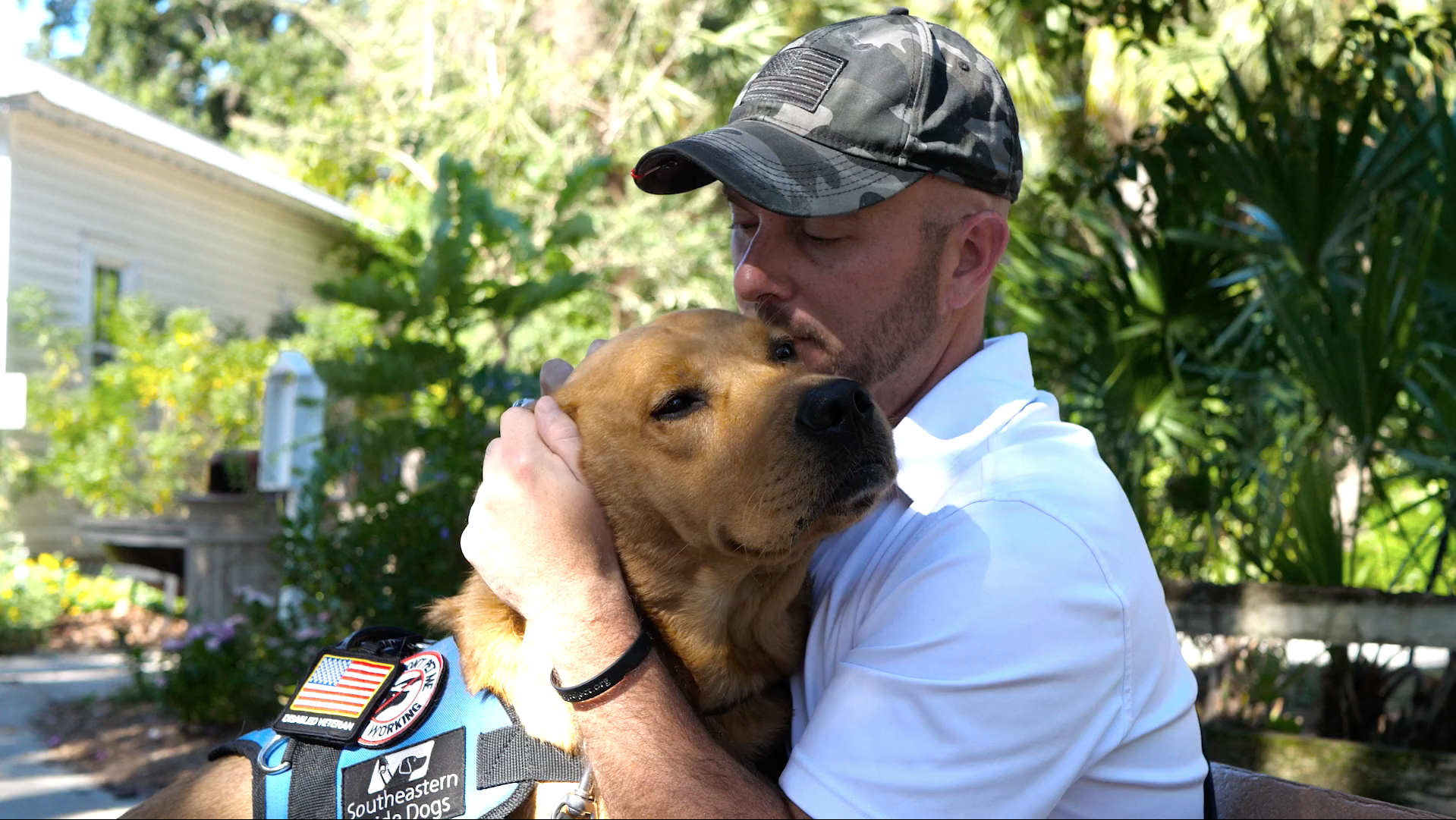Veteran is hugging his service dog