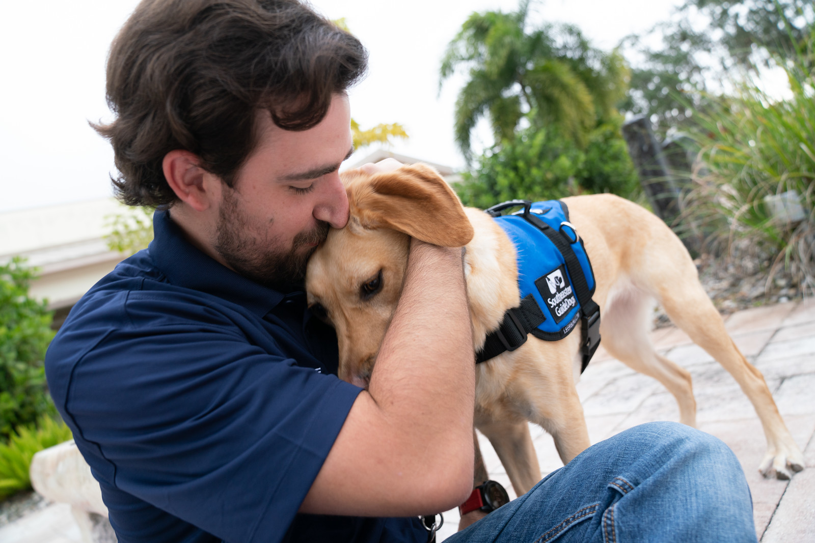 yellow emotional support dog with man