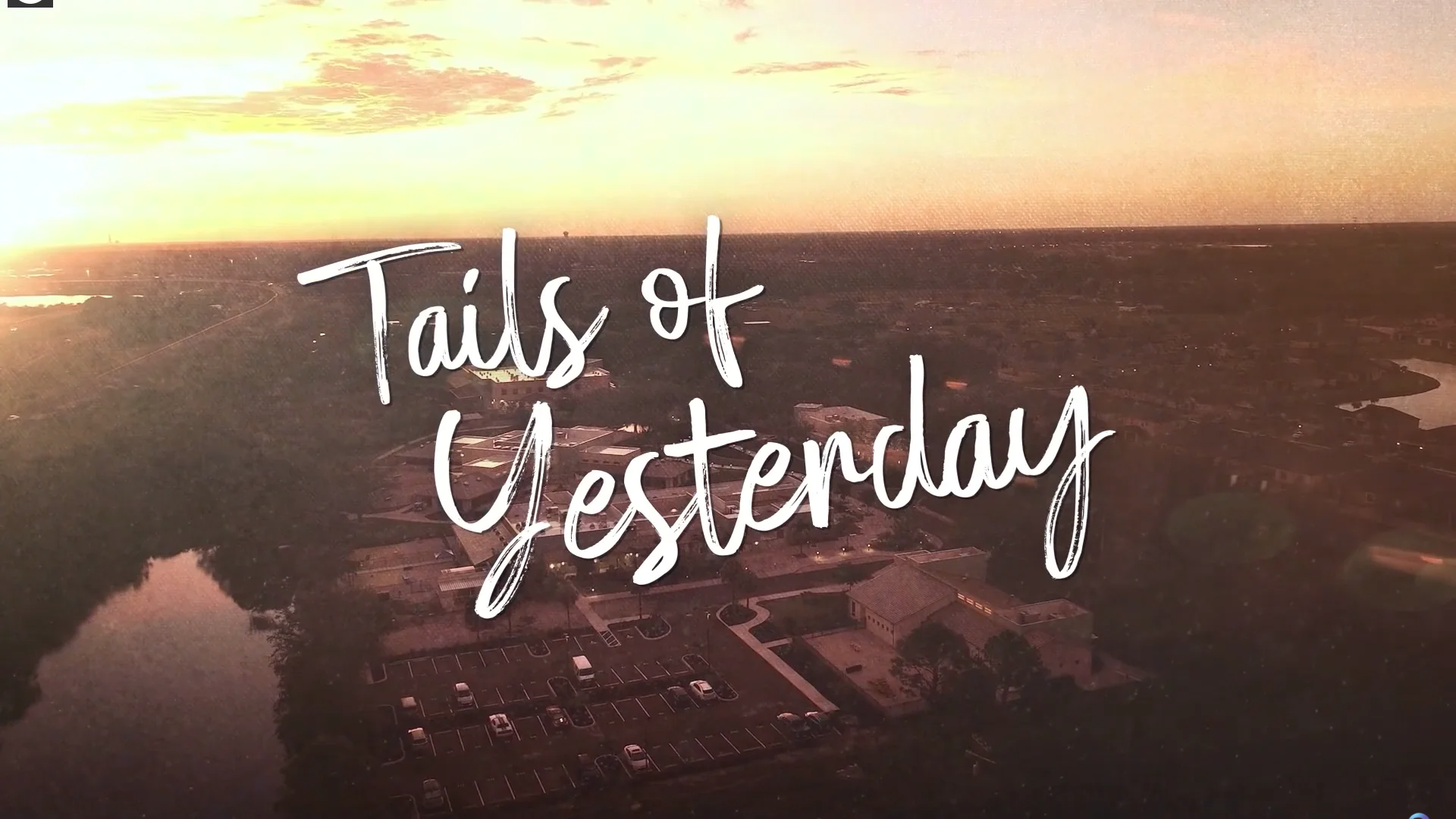 Text: Tails of Yesterday, pictured with an aerial view of the campus