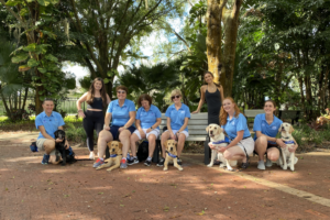 A group of puppy raisers with various puppies