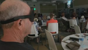 A photo of a man wearing a blindfold in the audience of "Beyond the Dark."