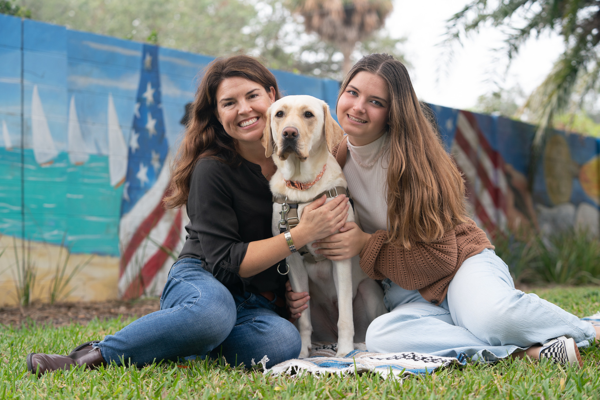 A photo of Emily and Isabella Hoey with Gold Star Family Dog Elle