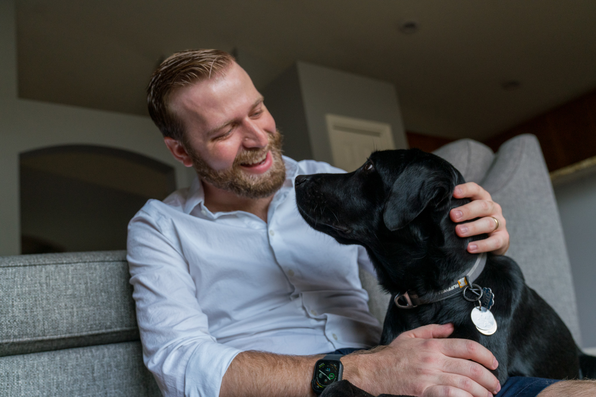 A black lab looking up into his owner's eyes 