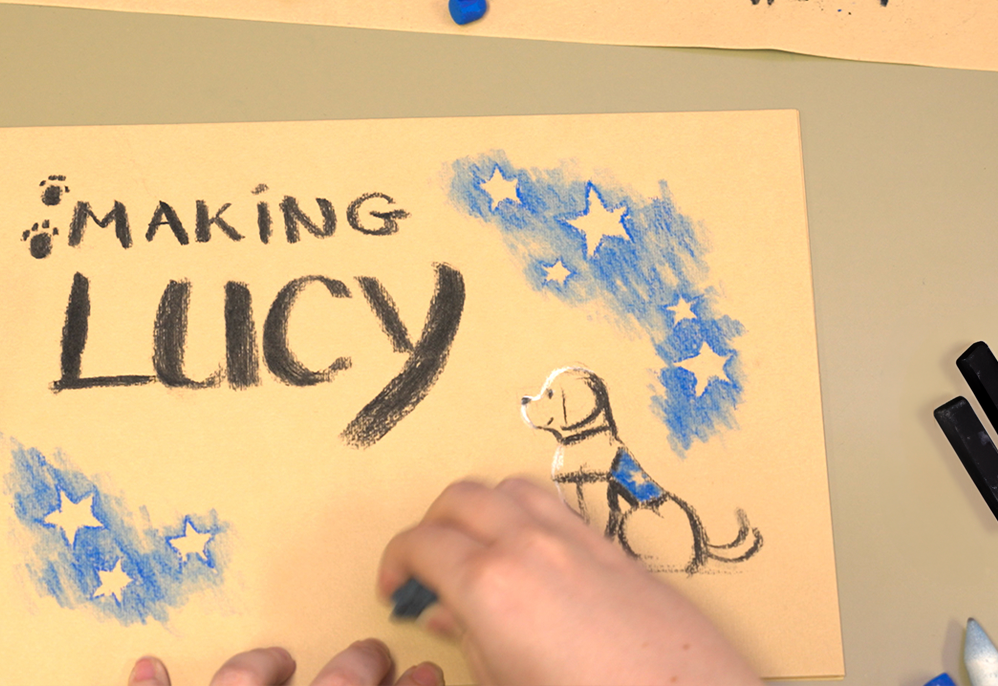 A drawing of a service dog with "Making Lucy" text.