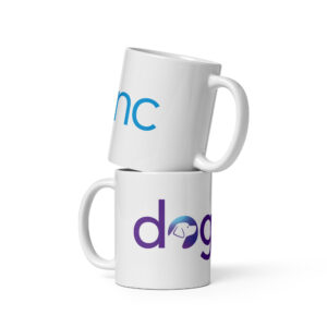 A white coffee mug with the Dogs Inc logo centered in purple and blue.
